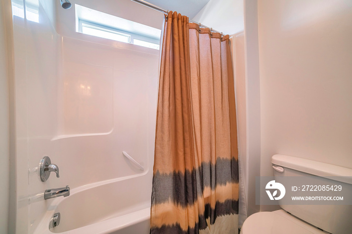 Traditional bathroom with brown shower curtain with black stripes