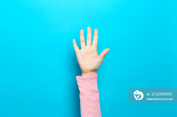 Person raising their hand up on a blue background