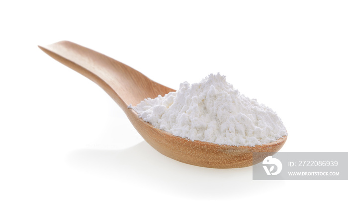 Pile of white wheat flour in wooden spoon