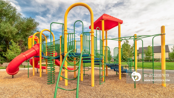 Panorama frame Colorful playground equipment with tube slide bridge climbing bars and stairs