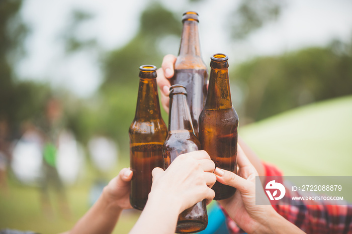 Bottles of beer.Group of friends enjoying party.people are drinking beer and laughing . The guy play