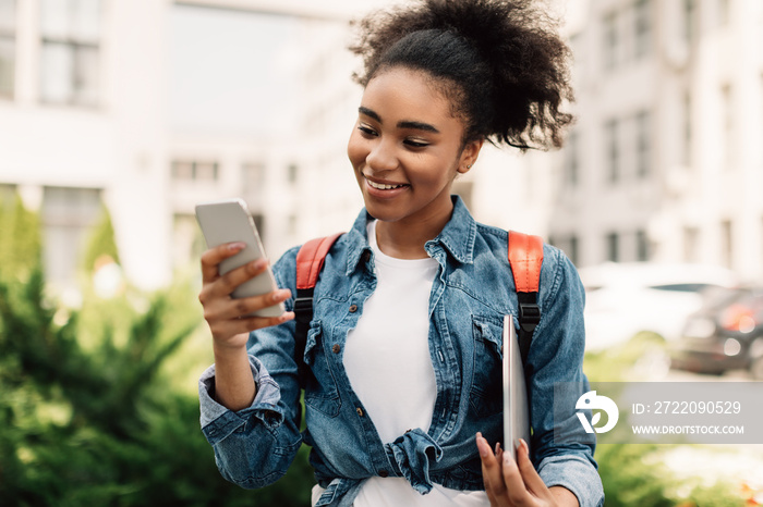 Happy Black College Girl Using Smartphone Texting Outdoor