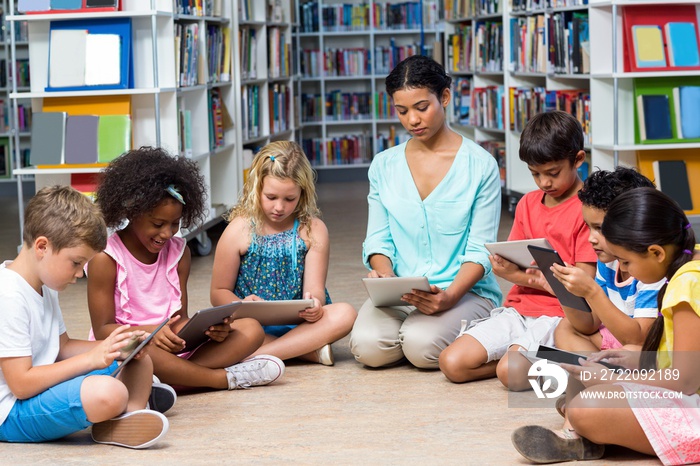 Teacher with children using digital tablet