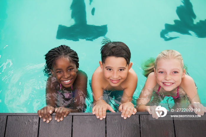 Cute swimming class in pool with coach