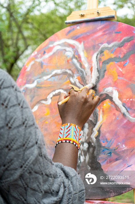 close up of female painters hand from behind