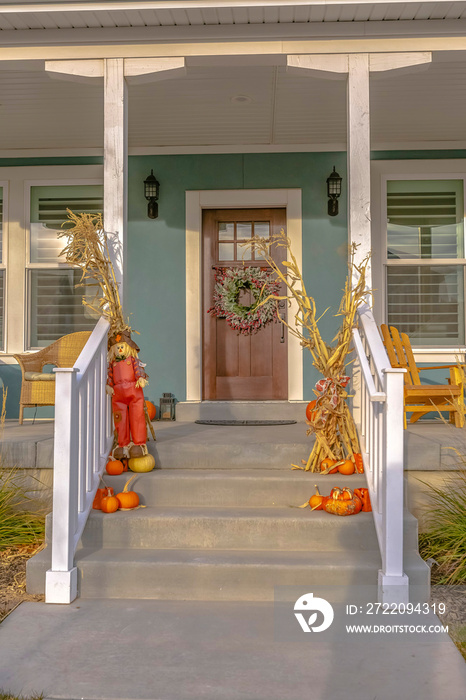 Entry with fall decoration pumpkins and scarecrow