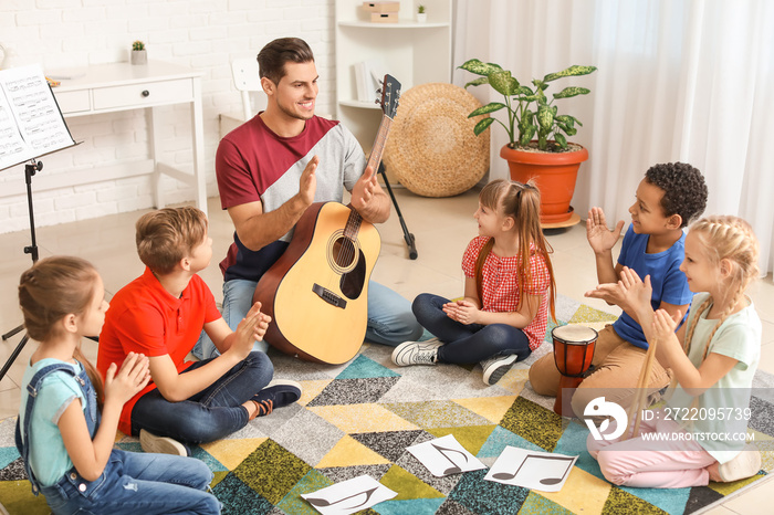 Teacher giving music lessons at school