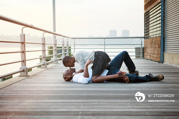 Couple embracing on wooden pier