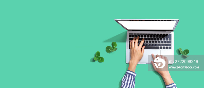 Laptop computer with shamrock leaves - flat lay