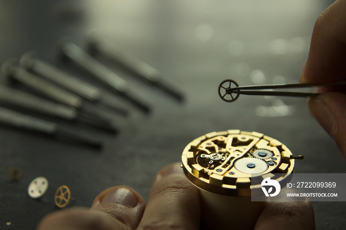 Watchmaker repairs a mechanical watches