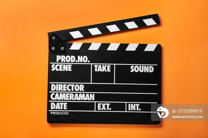 Cinema clapperboard on color background