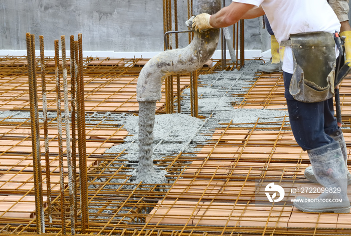 Workers pouring concrete with motion blur