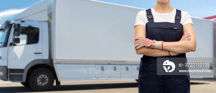 freight transportation, job and profession concept - close up of female worker or car mechanic in overall over truck on background