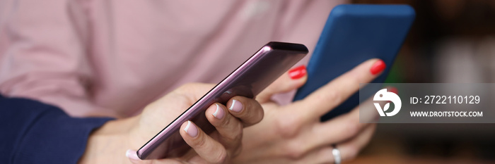 Two smartphones in female hands. Chatting closeup