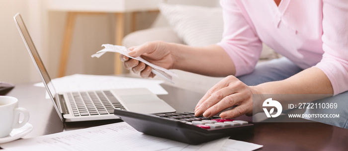 Senior lady calculating bills at home, panorama