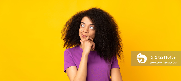 Young african american woman over isolated background having doubts and with confuse face expression