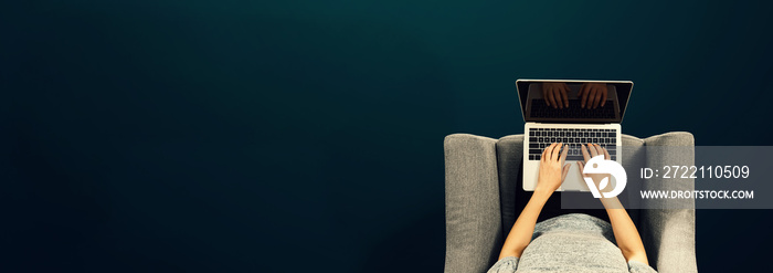 Woman using a laptop computer overhead view