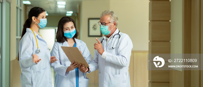 Professional  doctors  wearing mask consult while walking  at hospital