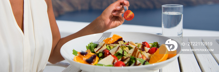 Healthy woman eating salad banner crop of diet meal at restaurant table. Closeup of plate on outdoor cafe terrace plate, luxury dining.