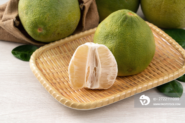 Fresh pomelo fruit on wooden table background.