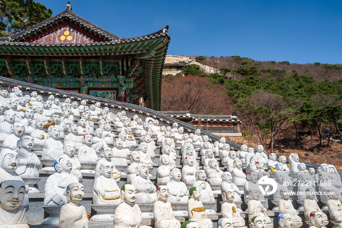 Many of the 500 Buddha’s Disciples statues by a temple hall in Bomunsa Temple on the island of Seongmodo, Ganghwa, Incheon, South Korea.