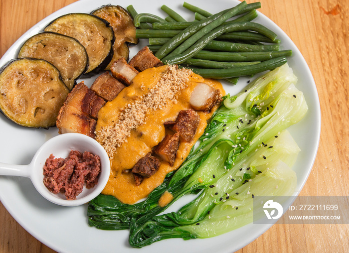 Crispy kare kare, pork belly are sauce with peanuts and vegetables, Filipino cuisine.