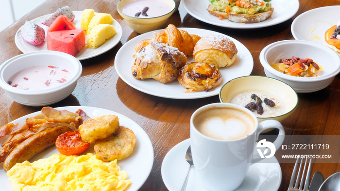 Breakfast in restaurant - fresh pastries, fruits, omelette, toast, yogurt