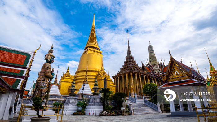 Beautiful landscape of Wat Phra Si Rattana Satsadaram (Wat Phra Kaew) or Temple of the Emerald buddha over blue sky and white cloud. Most popular temple of tourist in Bangkok, Thailand