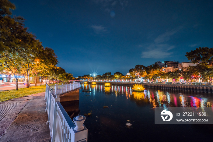 Floating colored lotus lanterns on river at night on Vesak day for celebrating Buddha’s birthday in Eastern culture