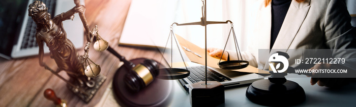 Justice and law concept.Male judge in a courtroom with the gavel, working with, computer and docking keyboard, eyeglasses, on table in morning light