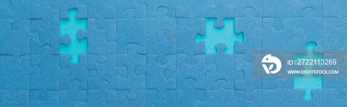 panoramic shot of blue jigsaw puzzle with lighter gaps