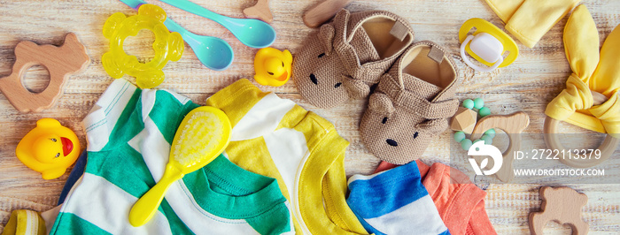 Baby clothes and accessories on a light background. Selective focus.