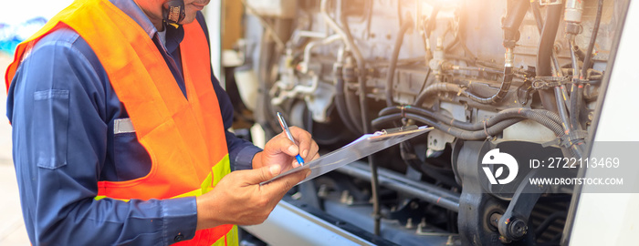 Preforming a pre-trip inspection on a truck,Concept preventive maintenance truck checklist,Check truck engine,Check the lubricating oil,spot focus.