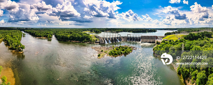 An aerial 180 degree panoramic view of a large dam and hydroelectric plant on the Catawba river in South Carolina and Lake Wylie in the background.