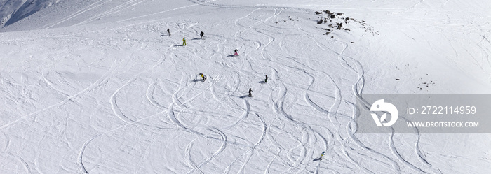 Snowboarder downhill on off piste slope with newly-fallen snow