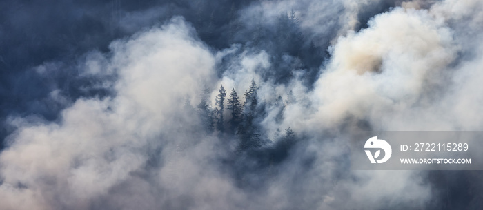 BC Forest Fire and Smoke over the mountain near Hope during a hot sunny summer day. British Columbia, Canada. Wildfire natural disaster