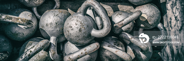 Gym background panorama banner. Crossfit training workout texture of numerous kettlebell weights for weightlifting. Fitness center kettlebells for cross training panoramic.