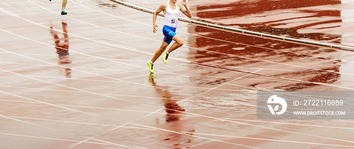 athlete runner run on wet track in rain at track and field competition