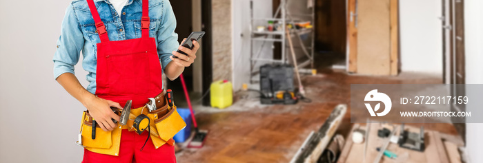 Builder handyman with construction tools. House renovation background.