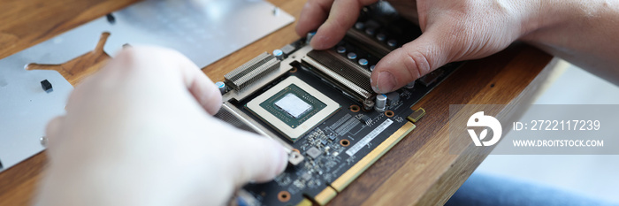 Master repairing video card in workshop closeup