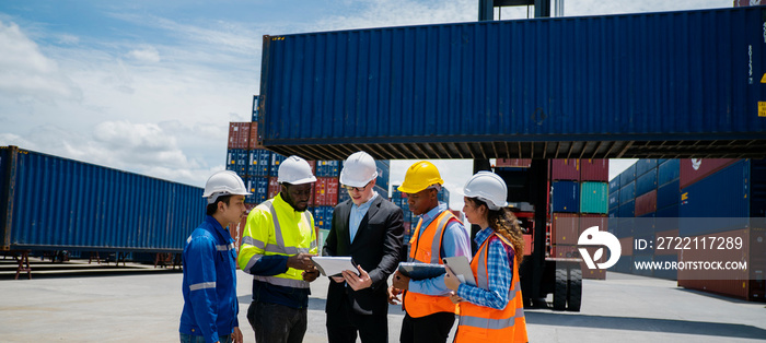 Group of engineer worker and manager standing in the shipping yard container.