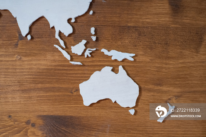 Handcrafted wooden world map with focus on Southeastern Asia and Oceania