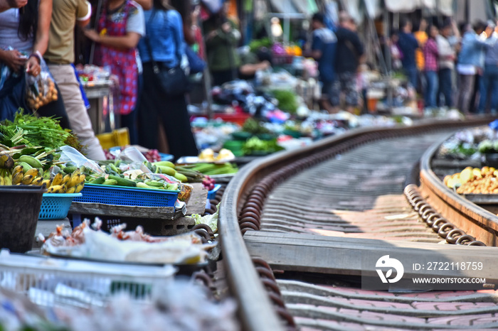 Selling food on the Maeklong Railway market in Thailand