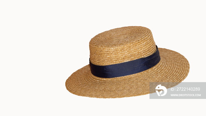 Beautiful straw hat with ribbon and bow on summer beach hat. White background from side view