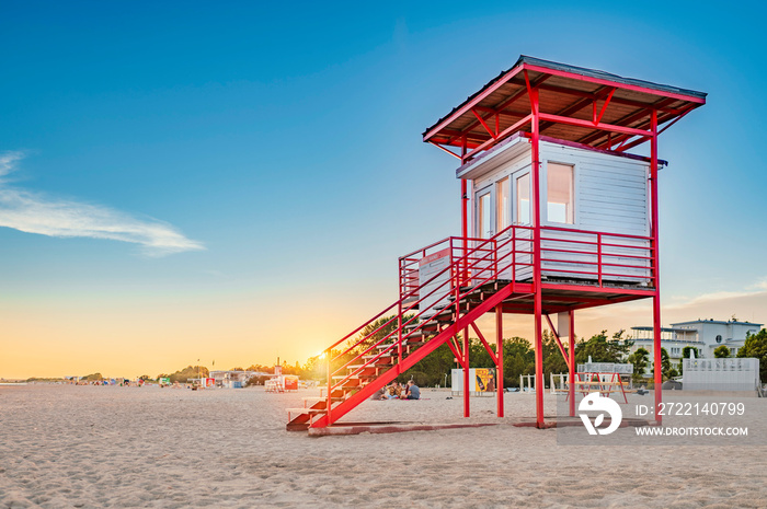 Parnu beach in Estonia during sunny summer sunset, life guard tower in foreground