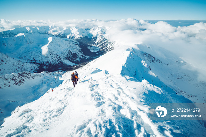 A group of climbers ascending a mountain in winter