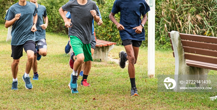 Group of teenage boys running in a park