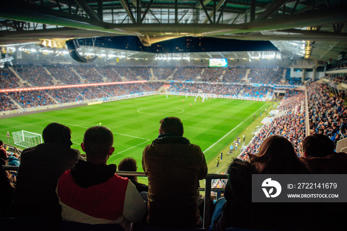 Fans watching the game at soccer stadium, football photo