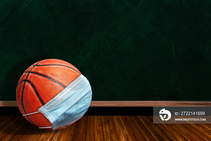 Basketball Wearing Mask With Chalkboard Background and Copy Space