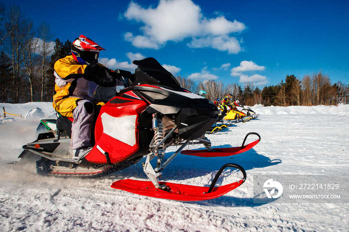 Snowmobile. Snowmobile races start in snow. Concept winter sports, racers.